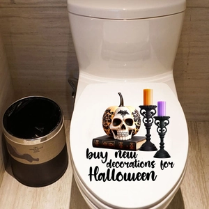 Halloween toilet lid sticker featuring pumpkin skull, candles, and spooky decorations