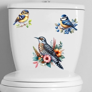 Detailed view of three watercolor birds and berries stickers on a white surface