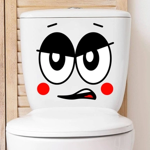 Close-up of minimalist cartoon smiley face decal applied to a white toilet water tank