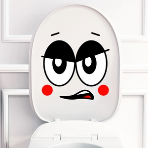 Funny minimalist smiley face vinyl wall sticker applied on a white toilet lid surface