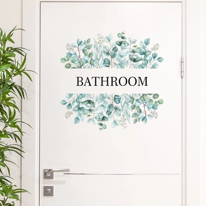 Minimalist eucalyptus watercolor bathroom door sticker on white wooden surface