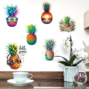 Detail of colorful pineapple wall stickers featuring Hello Summer text on a white home wall