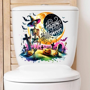 Detail of Happy Halloween toilet stickers with skulls, bats, and pumpkin on white surface