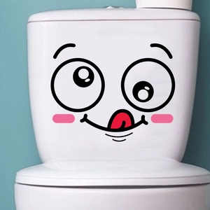 Close-up of cute cartoon smiley face sticker on a white ceramic toilet tank surface