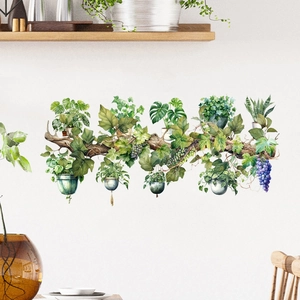 Watercolor potted plants wall decal featuring monstera leaves and ivy on a white wall
