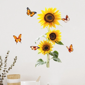 Detail of sunflower and butterfly wall decals on a clean white wall with home decor items