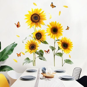 Detail of sunflower and butterfly wall decals applied on a clean white living room wall