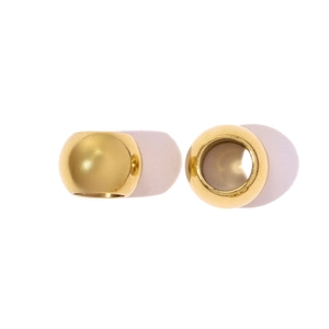 Detailed view of two gold-plated stainless steel hollow beads for DIY jewelry making