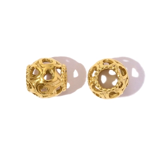 Close-up of golden hollow heart-shaped stainless steel beads for DIY jewelry making