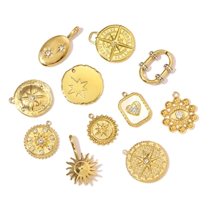 Collection of gold-plated stainless steel starburst and compass pendants with crystals