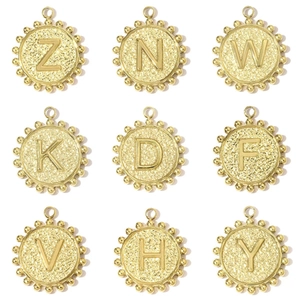 Macro shot of 9 gold hammered square initial charms with decorative beaded edge details