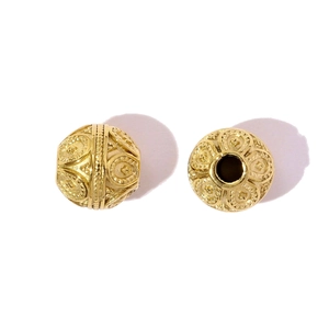 Macro view of golden hollow heart beads with vintage patterns for DIY jewelry