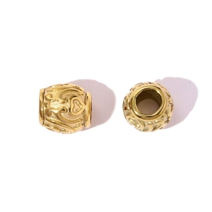 Detail showing hollow heart pattern and scrollwork on golden stainless steel beads