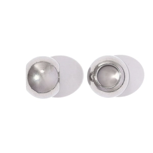 Detailed macro view of polished stainless steel spacer beads with smooth mirror finish