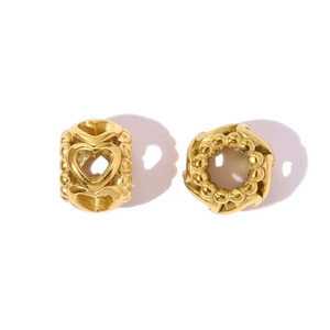 Macro detail of gold-plated hollow heart and beaded pattern stainless steel beads