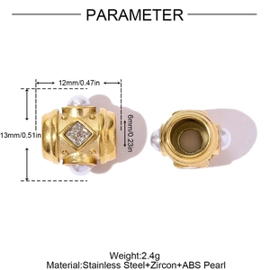 Detailed view of hollow heart-shaped gold charm with zircon and pearl, 6mm hole size