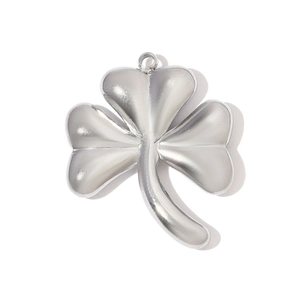 Macro detail of polished stainless steel clover pendant with reflective mirror finish