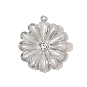 Close-up of flower pendant in stainless steel with center cubic zirconia stone