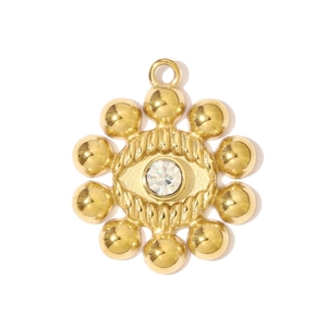 Macro shot of gold stainless steel sunburst pendant with sparkling center zircon stone