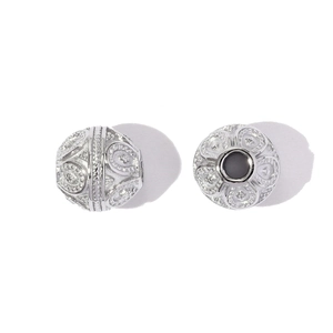 Detailed macro view of intricately engraved stainless steel spacer beads for DIY jewelry