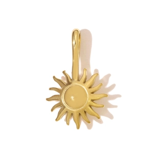 Detail of a gold sun-shaped stainless steel pendant with central sphere and flame rays