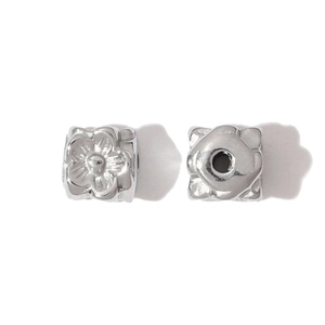 Detailed close-up of two flower-shaped stainless steel spacer beads for DIY jewelry