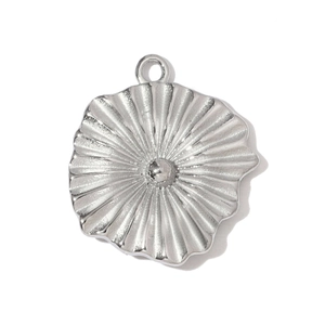 Macro detail of sunburst pattern stainless steel pendant for jewelry making