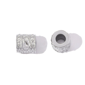 Macro detail of silver stainless steel infinity charm bead with textured relief pattern