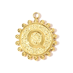 Detailed macro view of gold-plated square pendant with embossed letter Q and hammered texture