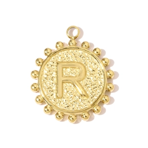 Macro detail of a square hammered titanium steel pendant with an engraved letter R