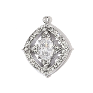 Detailed macro view of diamond-encrusted silver pendant with starburst and heart motifs