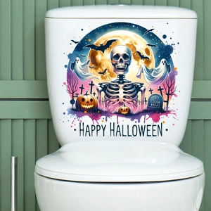 Detail of Halloween toilet decals featuring skeletons and pumpkins on white ceramic tank