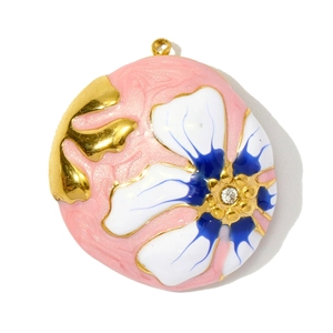 Detail of round floral enamel pendant with blue patterns and center sparkling zircon