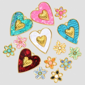 Detailed view of colorful resin heart and flower charms for DIY jewelry making sets
