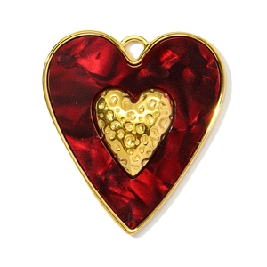 Detail of red marble textured heart pendant with a hammered gold center and loop