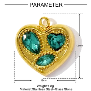 Vue détaillée d'un pendentif coeur doré en acier avec trois pierres de verre vertes