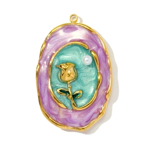 Detail of vintage oval pendant with golden rose relief and lake green enamel finish
