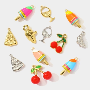 Detailed macro shot of DIY titanium steel charms including cherry and pizza designs