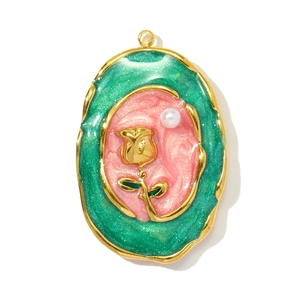 Detail of oval vintage gold pendant with green glitter resin and rose relief