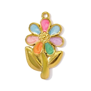Macro detail of a colorful enamel flower pendant with gold plating and sparkling glitter