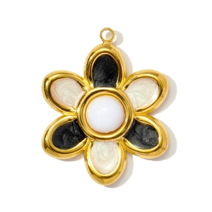 Detail of a floral stainless steel pendant with black and white enamel and a pearl center