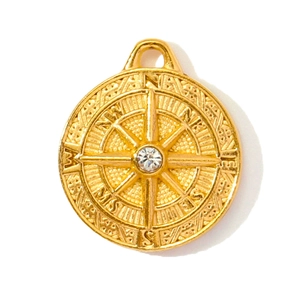 Detailed close-up of a gold stainless steel compass pendant with a sparkling zircon center
