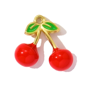 Detailed close-up of cherry pendants with red enamel finish and golden metal edges