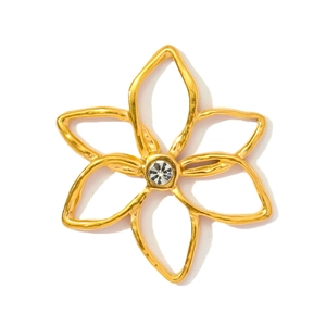 Macro shot of gold floral steel pendant with hollow petals and a central zircon