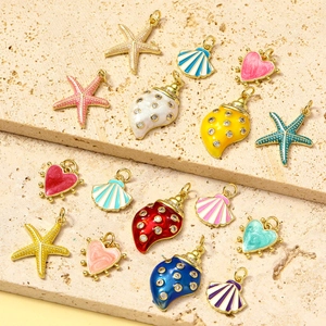 Vibrant ocean theme pendants featuring colorful starfish and shells with gold-plated finish