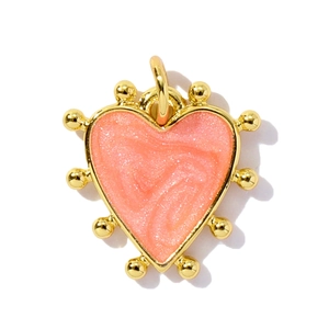 Golden heart pendant with pink glitter enamel inlay and beaded border on white background