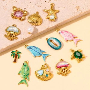 Golden ocean-themed stainless steel charms including shell, crab, and jellyfish pendants