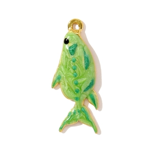 Macro detail of fish pendant with green enamel resin and gold-plated steel edges