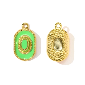 Vue macro d'un pendentif ovale plaqué or avec émail vert 'O' pour bijoux DIY