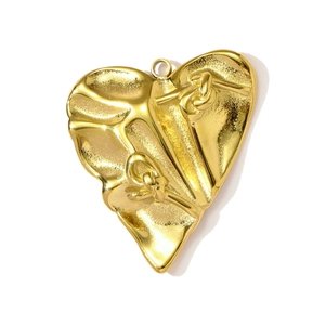 Detail showing vintage gold heart pendant with unique folded texture and knot design